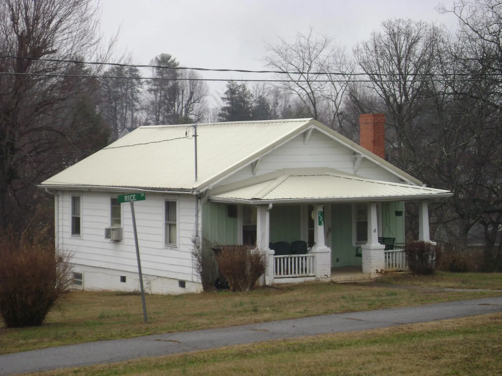 White metal roof on a craftsman bungalow at a street corner in East Greenwich
