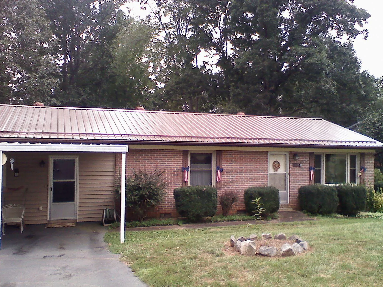 Bronze metal roof and carport on a brick ranch home — Roof Repair work by our crew in East Greenwich